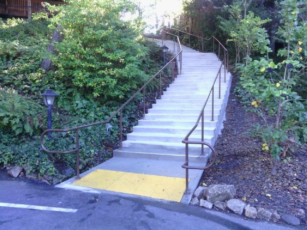 Iron handrail and safety barrier installed on a commercial stairway in Sacramento, providing durability and secure fencing.