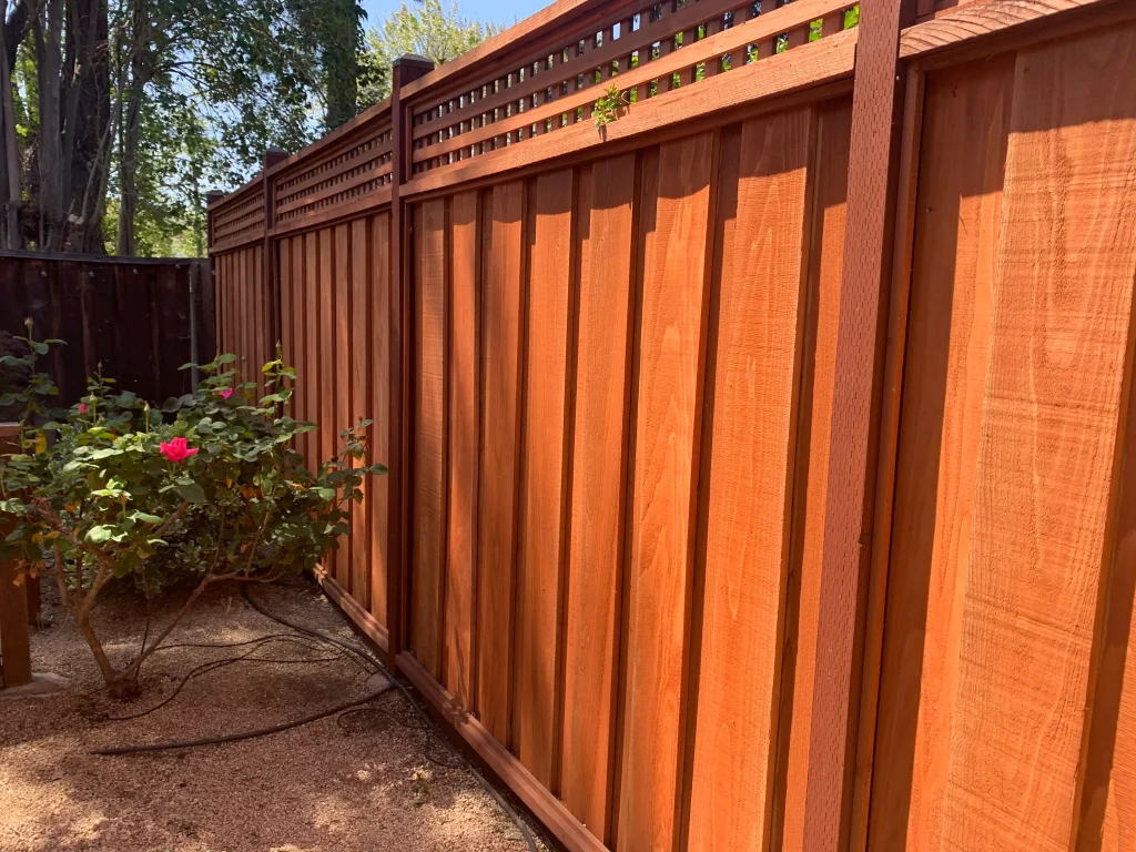 Antelope Board on Board Fence Construction A durable board on board redwood fence in Antelope, showing layered overlapping boards, tight spacing, and a clean top cap designed to maximize privacy and security.